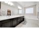 Bright bathroom featuring a large vanity with double sinks and a separate soaking tub at 1172 Strada Pecei, Henderson, NV 89011