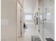A modern main bathroom with a glass shower, a soaking tub, and a tiled floor at 1172 Strada Pecei, Henderson, NV 89011