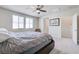 A cozy main bedroom with neutral color scheme, plush carpet, a ceiling fan, and a comfortable bed at 1172 Strada Pecei, Henderson, NV 89011