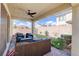 Covered outdoor patio with comfortable seating and a view of the landscaped backyard at 1172 Strada Pecei, Henderson, NV 89011