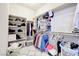 Well-organized walk-in closet with shelving and hanging space for clothes and accessories at 1172 Strada Pecei, Henderson, NV 89011
