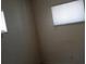 Neutral bedroom with two small window, blind and view of the interior of the house at 1316 Lawry Ave, Las Vegas, NV 89106