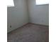 Neutral bedroom with a small window, blind and view of the interior of the house at 1316 Lawry Ave, Las Vegas, NV 89106