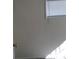 Neutral bedroom with a small window, blind and view of the interior of the house at 1316 Lawry Ave, Las Vegas, NV 89106