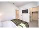Comfortable bedroom featuring a TV and ensuite closet entrances at 187 Palm Fox Ct, Henderson, NV 89011