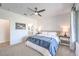 Bright bedroom featuring bedside tables and a large window with patterned curtains at 187 Palm Fox Ct, Henderson, NV 89011