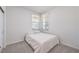 Modest bedroom featuring a window with blinds and a comfortable mattress on a bed frame at 187 Palm Fox Ct, Henderson, NV 89011