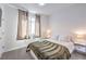 Comfortable bedroom featuring a large window with curtains and white nightstands at 187 Palm Fox Ct, Henderson, NV 89011