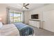 Bright bedroom featuring a ceiling fan, a TV, and a large window with scenic views at 187 Palm Fox Ct, Henderson, NV 89011