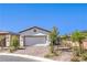 Charming single-story home featuring a brick driveway and a neutral-colored exterior with a two-car garage at 187 Palm Fox Ct, Henderson, NV 89011