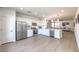 Open kitchen layout with stainless steel appliances, white cabinetry, and views into the adjacent living area at 187 Palm Fox Ct, Henderson, NV 89011
