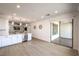 Bright kitchen area showcasing white cabinetry, stainless steel appliances, and a sliding glass door to the patio at 187 Palm Fox Ct, Henderson, NV 89011