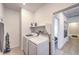 Bright laundry room with a washer, dryer, and ample shelving for storage at 187 Palm Fox Ct, Henderson, NV 89011