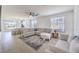 Open-concept living area with stylish furnishings, light wood floors, and large windows for ample natural light at 187 Palm Fox Ct, Henderson, NV 89011
