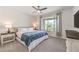Comfortable main bedroom featuring neutral decor, a ceiling fan, and a window with stylish curtains at 187 Palm Fox Ct, Henderson, NV 89011