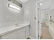 Clean bathroom with a bright vanity, marble countertop, and modern lighting at 1904 Chapman Dr, Las Vegas, NV 89104