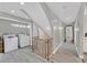 Hallway includes wood floors, staircase with ornate railing, and adjacent laundry room with modern washer and dryer at 1904 Chapman Dr, Las Vegas, NV 89104