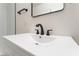 Modern bathroom with a white vanity, black hardware, and a sleek black faucet at 2 Utah Way, Henderson, NV 89015