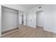 Neutral bedroom featuring wood-look floors and a mirrored closet at 2 Utah Way, Henderson, NV 89015