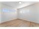 Neutral bedroom featuring wood-look floors and two windows at 2 Utah Way, Henderson, NV 89015