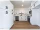 Modern kitchen features white cabinets, stainless steel appliances, and hardwood floors at 2 Utah Way, Henderson, NV 89015