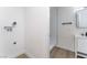 A bright laundry area next to a bathroom with modern fixtures and wood-look flooring at 2 Utah Way, Henderson, NV 89015