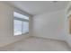 Bright, airy bedroom with carpet flooring and natural light from the large window at 2101 High Mesa Dr, Henderson, NV 89012