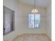 Bright dining area featuring tile flooring, and natural lighting with a decorative chandelier at 2101 High Mesa Dr, Henderson, NV 89012