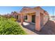 Exterior view of a house with a covered patio, landscaped garden, and a glimpse of neighboring properties at 2101 High Mesa Dr, Henderson, NV 89012