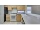 Bright kitchen with light wood cabinets, modern appliances, and tile flooring at 2101 High Mesa Dr, Henderson, NV 89012