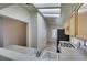 Bright kitchen featuring modern appliances, white countertops and skylight at 2101 High Mesa Dr, Henderson, NV 89012