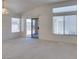 Living room featuring carpet flooring, multiple windows and sliding glass door to patio at 2101 High Mesa Dr, Henderson, NV 89012