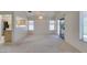 Living room featuring carpet flooring, multiple windows and a view into the kitchen at 2101 High Mesa Dr, Henderson, NV 89012