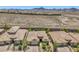 Expansive aerial view of a desert community showcasing well-maintained homes and scenic mountain views at 2509 Chateau Napoleon Dr, Henderson, NV 89044