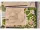 An aerial view of a home's tile roof and desert landscaping featuring an outdoor kitchen, a firepit, and artificial grass at 2509 Chateau Napoleon Dr, Henderson, NV 89044