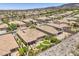Beautiful aerial of a community, complete with desert landscaping, and neighborhood streets at 2509 Chateau Napoleon Dr, Henderson, NV 89044
