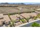Wide aerial shot of a desert community featuring neatly arranged homes and picturesque mountain vistas at 2509 Chateau Napoleon Dr, Henderson, NV 89044