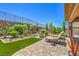 Well-maintained backyard featuring lush landscaping, lounge chairs, a paved patio, and a serene ambiance at 2509 Chateau Napoleon Dr, Henderson, NV 89044