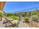 Spacious backyard oasis with lush landscaping, lounge chairs, and a serene, inviting atmosphere at 2509 Chateau Napoleon Dr, Henderson, NV 89044