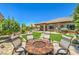 Relaxing backyard patio featuring a stylish fire pit and comfortable seating, ideal for outdoor gatherings at 2509 Chateau Napoleon Dr, Henderson, NV 89044