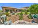 Lush backyard with desert landscaping, a cozy patio, and manicured artificial turf, perfect for outdoor enjoyment at 2509 Chateau Napoleon Dr, Henderson, NV 89044
