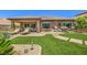 Beautiful backyard with a covered patio, lush lawn, lounge chairs, and ample space for outdoor enjoyment at 2509 Chateau Napoleon Dr, Henderson, NV 89044