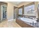 Bright bathroom features a large soaking tub, glass shower, and tile floors at 2509 Chateau Napoleon Dr, Henderson, NV 89044