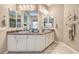 Bathroom features dual sinks, white cabinets, tile floors, and ample counter space at 2509 Chateau Napoleon Dr, Henderson, NV 89044