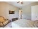 Bedroom features a ceiling fan, and a mounted TV at 2509 Chateau Napoleon Dr, Henderson, NV 89044