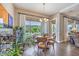 Cozy dining area with hardwood floors, round table, and views of the landscaped backyard at 2509 Chateau Napoleon Dr, Henderson, NV 89044