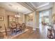 Elegant dining room with hardwood floors, coffered ceilings, and a chandelier, perfect for gatherings at 2509 Chateau Napoleon Dr, Henderson, NV 89044