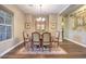 Elegant dining room with hardwood floors, coffered ceilings, and a chandelier, perfect for gatherings at 2509 Chateau Napoleon Dr, Henderson, NV 89044