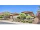 Charming single-story home with a tile roof, stone accents, and a meticulously manicured front yard at 2509 Chateau Napoleon Dr, Henderson, NV 89044