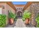 Inviting entryway featuring stone accents, brick pavers, and decorative potted plants enhancing curb appeal at 2509 Chateau Napoleon Dr, Henderson, NV 89044